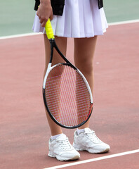 Girl with a racket on the tennis court