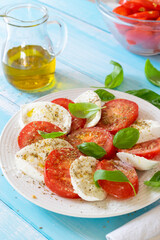 Classic Caprese Salad, a traditional Italian recipe with tomato, mozzarella and fresh basil.