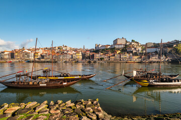 Fototapeta na wymiar Porto Portugal, city skyline at Porto Ribeira and Douro River with Rabelo wine boat