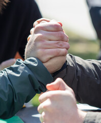 Strong male hands compete in arm wrestling