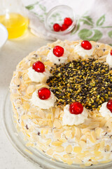 Fedora Cake, a traditional Sicilian cake with ricotta, pistachios and almonds, made up of two discs of sponge cake filled with ricotta cream.