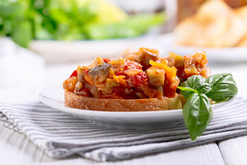 Stewed vegetables on a slice of bread.