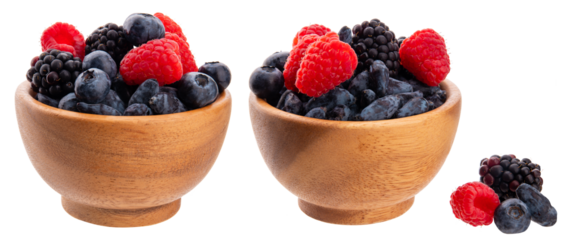 Wild berries in a wooden bowl isolated on transparent background png. Fresh ripe raspberries, blueberries, blackberries and honeysuckle        