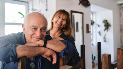 Happy senior cafe owners in coffee shop