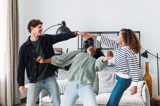 Happy family havin fun dancing together in the living room