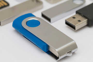 Macro shot of USB pen drive resting on a studio background.