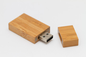 Macro shot of wooden USB pen drive resting on a studio background.