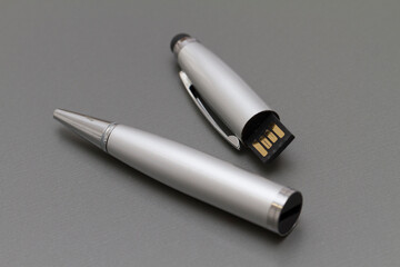 Macro shot of USB pen drive resting on a studio background.