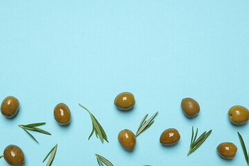 Olives and leaves on blue background, space for text