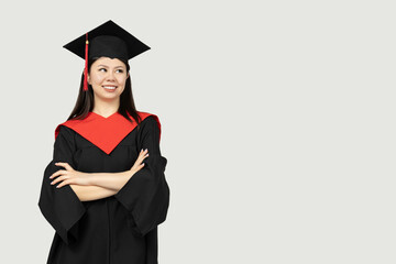 A girl of Asian appearance, a college graduate, on a gray background