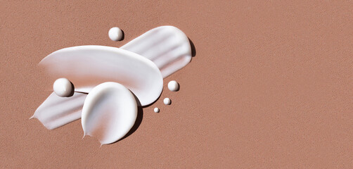 composition of smears of cream texture on a brown background