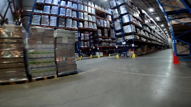 Moving through a modern warehouse. A forklift is driving through a large warehouse. Large modern warehouse in the factory
