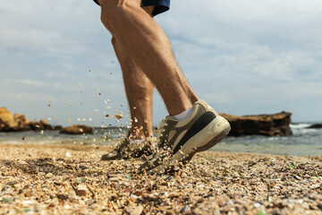 The concept of sports running on the beach, legs, close-up