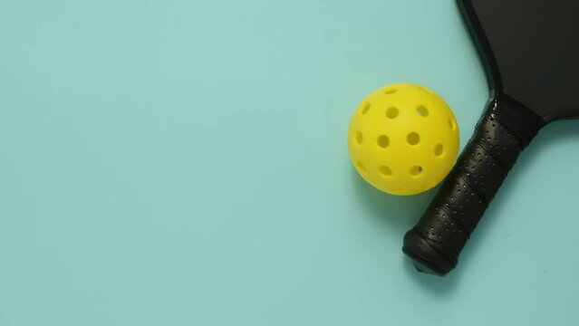 Closeup view of a yellow pickleball rolling towards the paddle. High quality FullHD footage
