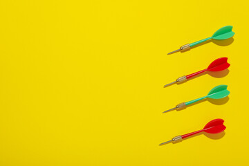 Darts for hitting the target on a yellow background.
