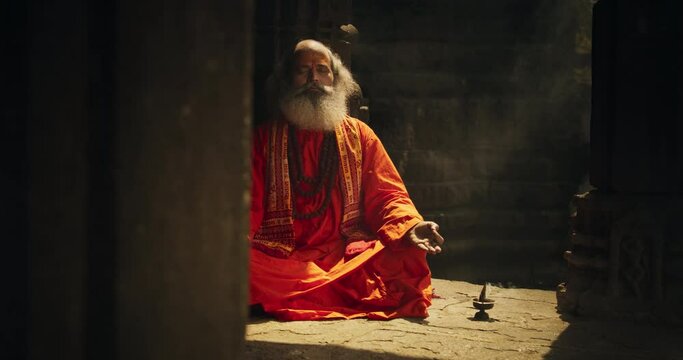Authentic Shot of An Indian Senior Monk Practicing Yoga In A Temple Setting. Serene And Meditative Display Of Ancient Spiritual Practice, Seeking Profound Sense of Inner Peace and Enlightenment
