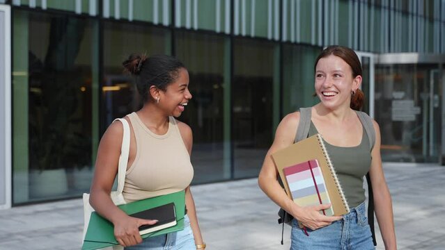 University student girl friends with learning books walking out School building - African American Youth