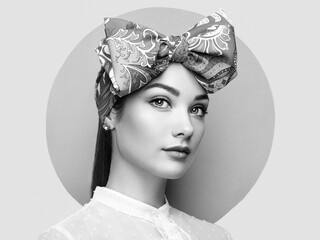 Portrait of beautiful young woman with bow. Brunette girl. Beauty fashion. Cosmetic make-up. Black and white