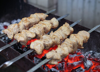Delicious juicy shish kebab. pork on fire. food on fire. barbecue in the yard. Georgian kebab. meat hot tasty dish. fried meat, juicy pork. cooking on a campfire. Georgian cuisine. meat on a skewer
