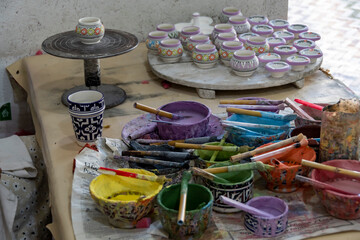 Workstation, with paints and brushes, in an artisan ceramics factory in Fes in Morocco.