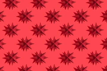 Glitter red or magenta stars decoration pattern on red background with shadows. Red festive background. Winter minimal holiday postcard. New Year or Christmas minimal flat lay concept