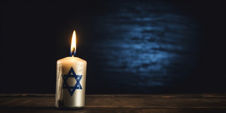 Burning candle and flag of Israel on a dark background.