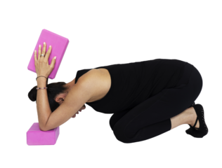 Trauma releasing exercises, senior citizen woman in her sixties, performing body strength and recovery exercises on the floor