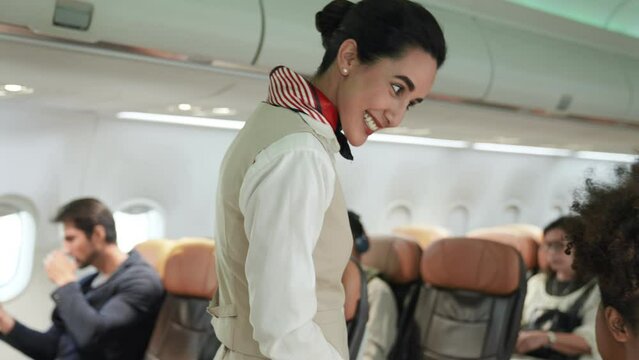 Smiling beautiful and attractive latin flight attendants Walk and greet passengers and check the safety of passengers. flight attendant checking on the plane Cabin crew or air hostess career concept.