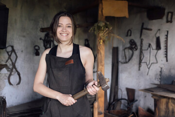 A young female entrepreneur has a small business in the production of metal craft products
