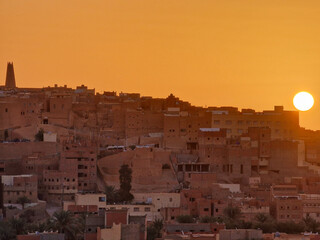 Sunset over a village in the Sahara desert 