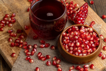 A small ripe red pomegranate is lying on the table