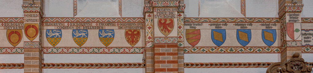 coats of arms in a frieze on the wall in Soro monastery church
