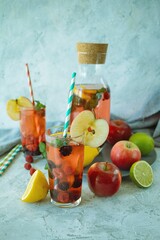 Refreshing summer sangria with berries, apples and lemon, a detox drink made from natural ingredients.