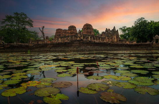 Prasat muang tam sanctuary stone castle on sunrise background famous landmark of Buriram province Thailand.