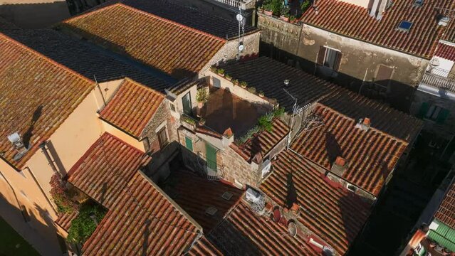 Fly Over Rooftops Of Ancient Settlements In The Village Of Pitigliano During Sunrise In Tuscany, Italy. Aerial Drone Shot