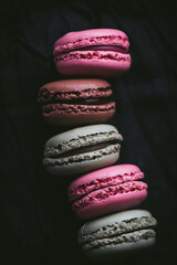 Macaroons on dark background, colorful french cookies macaroons