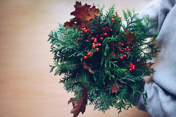 Rich autumn bouquet in the hands of a girl on a light background