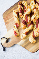 Puff pastry sticks. Close-up of puff pastry with prosciutto. 