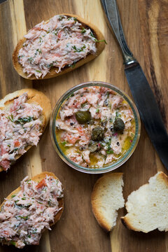 Salmon rillettes, mousse, pate and toasts on wooden background