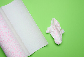 Soft white paper towel on a green background, disposable kitchen towel