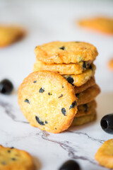Italian style round shortbread cookies with black olives and Parmesan cheese