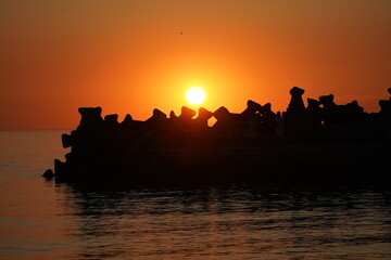 Sunrise at the sea. Strong colors of red, yellow and orange. Calm sea. Photography at sunrise.