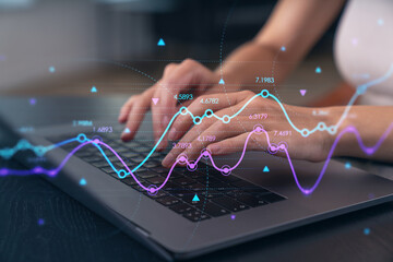 Woman typing on laptop at office workplace in background. Concept of working process, internet surfing, online business education. Student send e-mail. Close up view. forex graph and charts