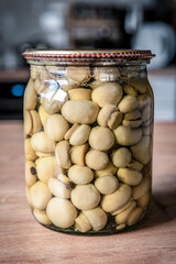 Delicious marinated pickled mushroom in the jar
