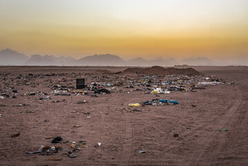 Different garbage in desert at sunset © Volodymyr Shevchuk