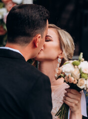 Bride and groom kissing on their wedding ceremony