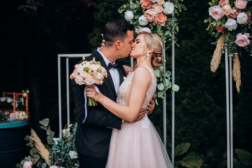 Bride and groom kissing on their wedding ceremony
