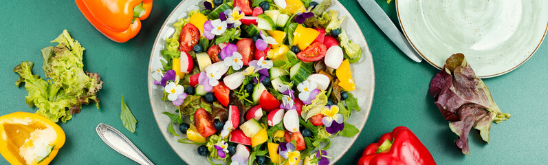 Tasty summer salad with edible flowers