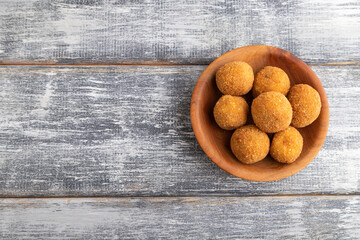 meat balls on a wooden plate on a gray. Top view, copy space.