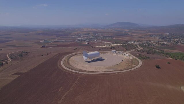 Landing complex of a huge zeppelin balloon to detect missiles coming from afar, on a mountain with a spectacular view - pullback shot